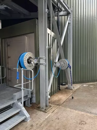 Two stainless steel hose reels installed on an elevated platform as part of the multi-point washdown system at an industrial site in Burton.